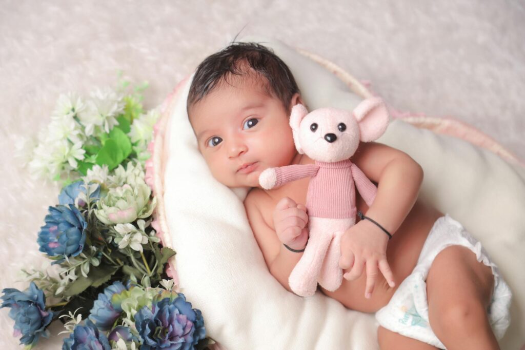 baby lying down with teddy toy