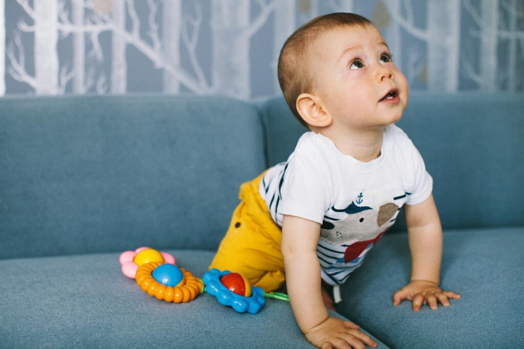 photo of a baby on a blue sofa
