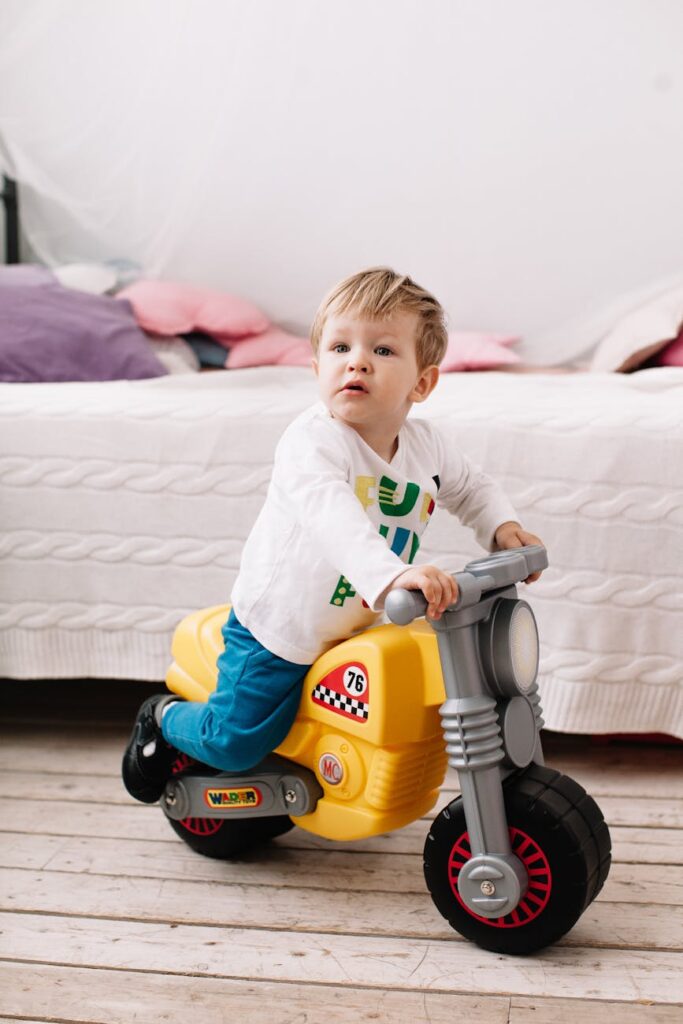 a boy riding a toy motorcycle