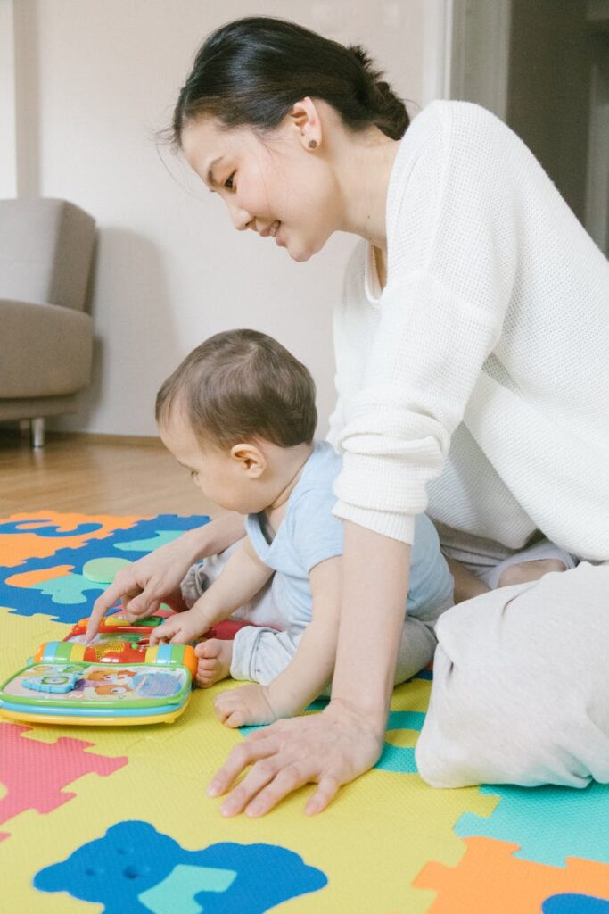 woman in white long sleeve shirt playing with child in blue shirt