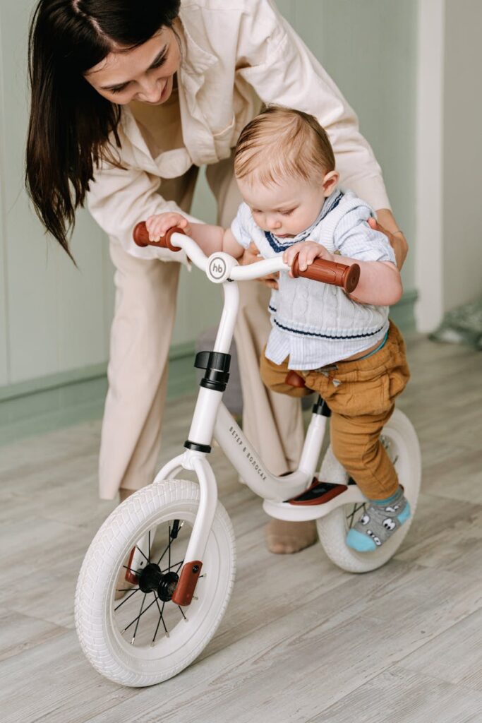 woman holding a baby seated on a bicycle
